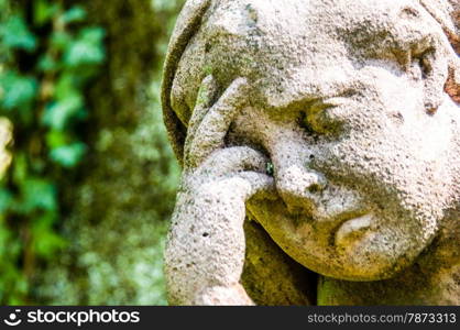 Mourning. detail of a mourning sculpture on a cemetery