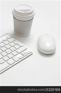 Mouse and keyboard and take away coffee