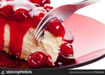 Mouth watering cherry cheesecake macro with fork. Shot on white background.