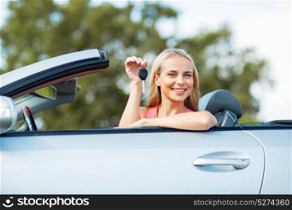 movable property, security and transport concept - happy young woman with convertible car key. happy young woman with convertible car key