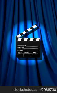 Movie clapper board against curtain