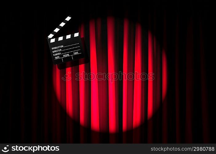 Movie clapper board against curtain