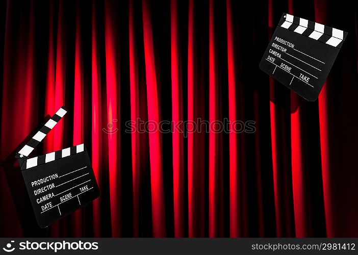 Movie clapper board against curtain