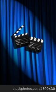 Movie clapper board against curtain