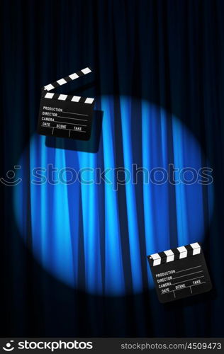 Movie clapper board against curtain