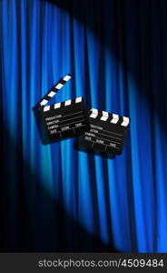 Movie clapper board against curtain