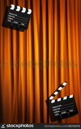 Movie clapper board against curtain