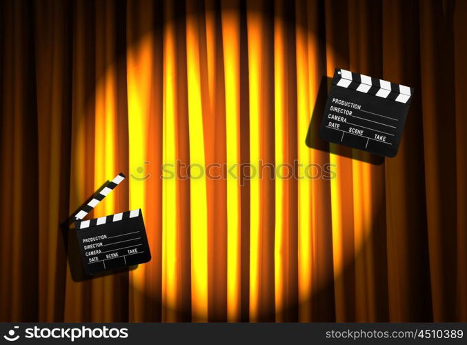 Movie clapper board against curtain