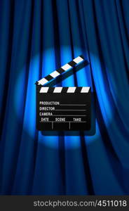 Movie clapper board against curtain