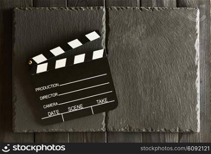 Movie production clapper board over slate background