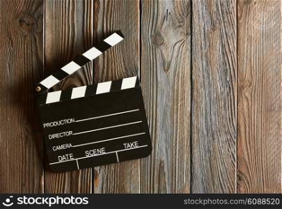 Movie production clapper board over wooden background