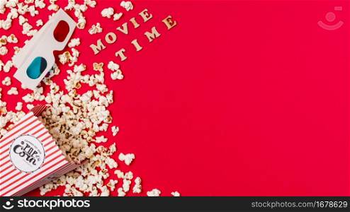 movie time text with 3d glasses spilled popcorn red background