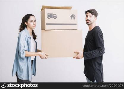 moving concept with couple carrying two boxes