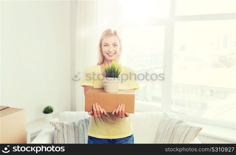 moving, delivery, accommodation and people concept - smiling young woman with cardboard box at home. smiling young woman with cardboard box at home