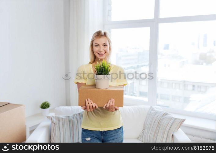 moving, delivery, accommodation and people concept - smiling young woman with cardboard box at home