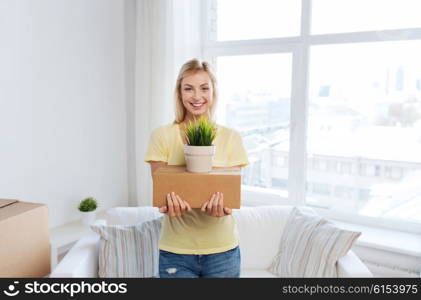 moving, delivery, accommodation and people concept - smiling young woman with cardboard box at home