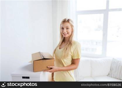 moving, delivery, housing, accommodation and people concept - smiling young woman with cardboard box at home
