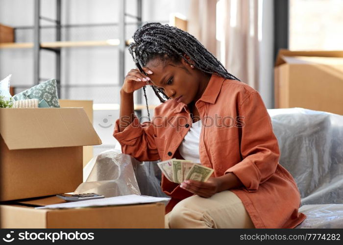 moving, finances and real estate concept - stressed woman with money, bills and calculator at new home. woman moving to new home and counting money