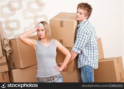 Moving house: Man and woman with box in new home