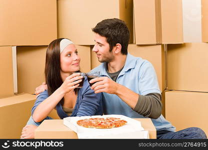 Moving into new home young happy couple have pizza lunch