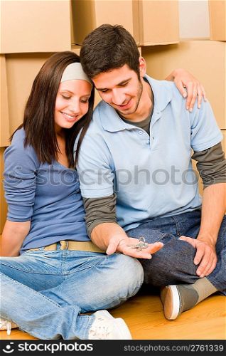 Moving into new home young happy couple holding house keys