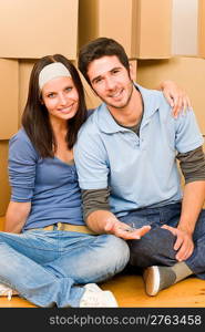 Moving into new home young happy couple holding house keys