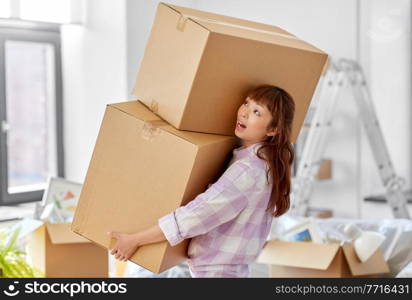 moving, people and real estate concept - asian woman holding big heavy boxes with stuff at new home. woman holding heavy boxes and moving to new home