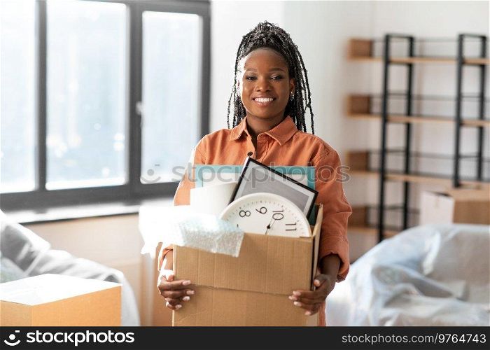 moving, people and real estate concept - happy smiling woman holding box at new home. happy woman with boxe moving to new home