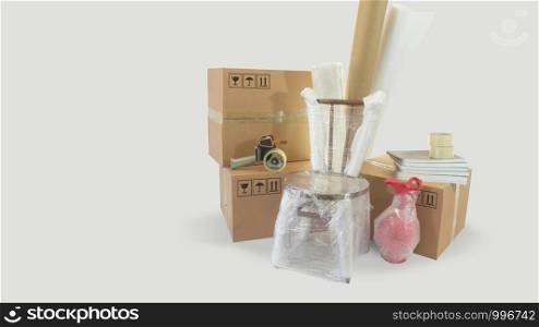 Moving scene with a chair and vase packed in plastic bubble with closed cardboard boxes and rolls of plastic and foam to pack on white background