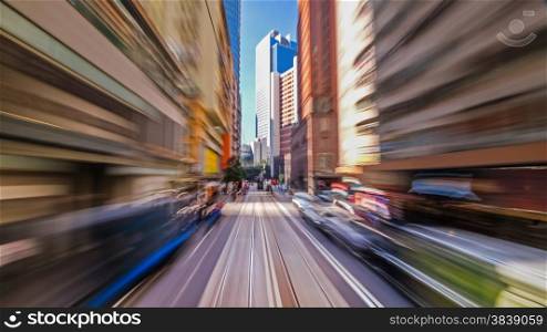 Moving through modern city street with skyscrapers. Hong Kong. Abstract cityscape traffic background with motion blur