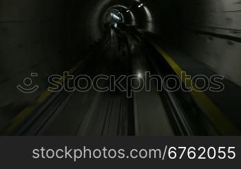 Moving train in subway tunnel, cabin view