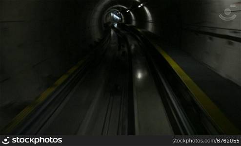 Moving train in subway tunnel, cabin view