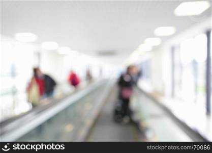 Moving walkway in airport out of focus