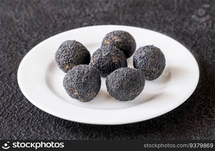 Mozzarella balls breaded with black truffle on the plate