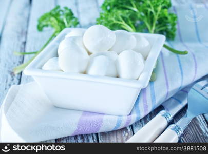 mozzarella in bowl and on a table