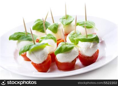 mozzarella with tomatoes and basil on white background