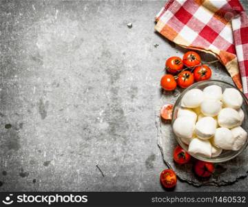 Mozzarella with tomatoes . On the stone table.. Mozzarella with tomatoes .