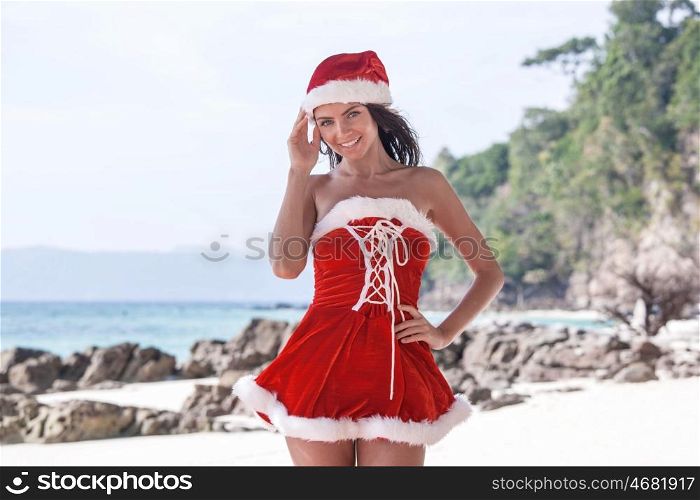 Mrs. Claus on tropical beach. Beautiful woman in Mrs. Claus custume on tropical beach, Christmas vacations concept