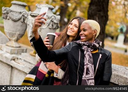 Mu<iracial fema≤friends taking selfie outdoor