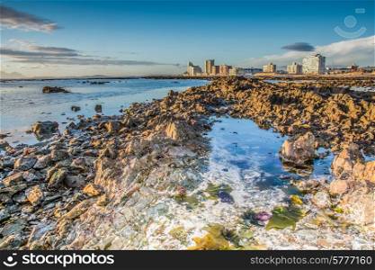 much of the reef is revealed during low tide infront of the Western Cape town known as Strand.