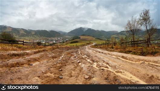 Muddy ground after rain in Carpathian mountains. Extreme path rural dirt road in the hills