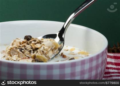 Muesli breakfast in a bowl and spoon close up