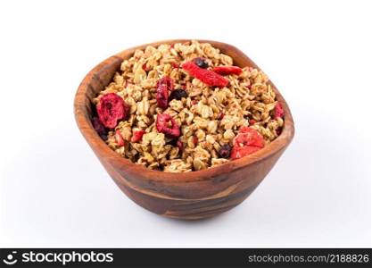 Muesli cereals in bowl with  raisins, oat and wheat flakes, fruits, strawberry, cranberry, cherry pieces. Isolated on white. Muesli cereals close up with  raisins, oat and wheat flakes, fruits, strawberry, cranberry, cherry pieces. Isolated on white