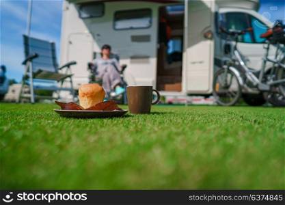 Muffin and Coffee Mug on grass. Caravan car Vacation. Family vacation travel, holiday trip in motorhome VR