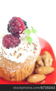 muffin with whipped cream,mint, raspberries, blackberries and nuts