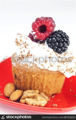 muffin with whipped cream, raspberries, blackberries and nuts