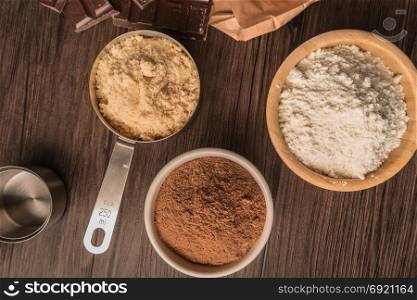 Muffins baking ingredients on wooden table.