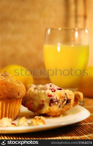 Muffins on a plate with a glass of orange juice