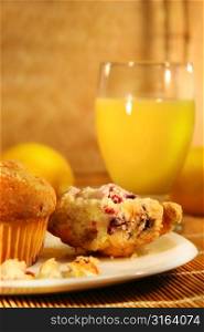 Muffins on a plate with a glass of orange juice