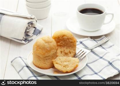 Muffins with coffee on white table
